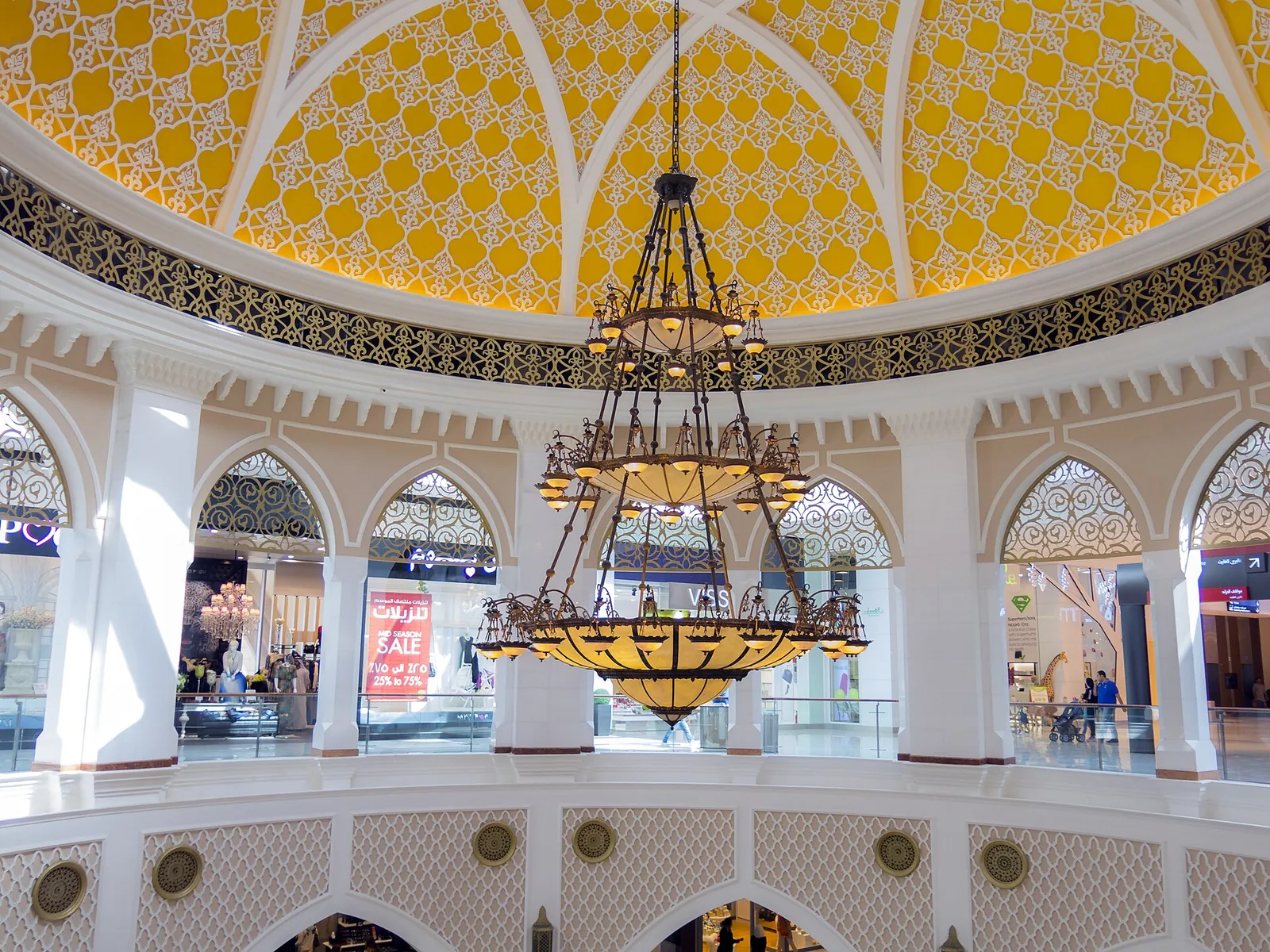 Ornate domed atrium with a large chandelier inside The Dubai Mall